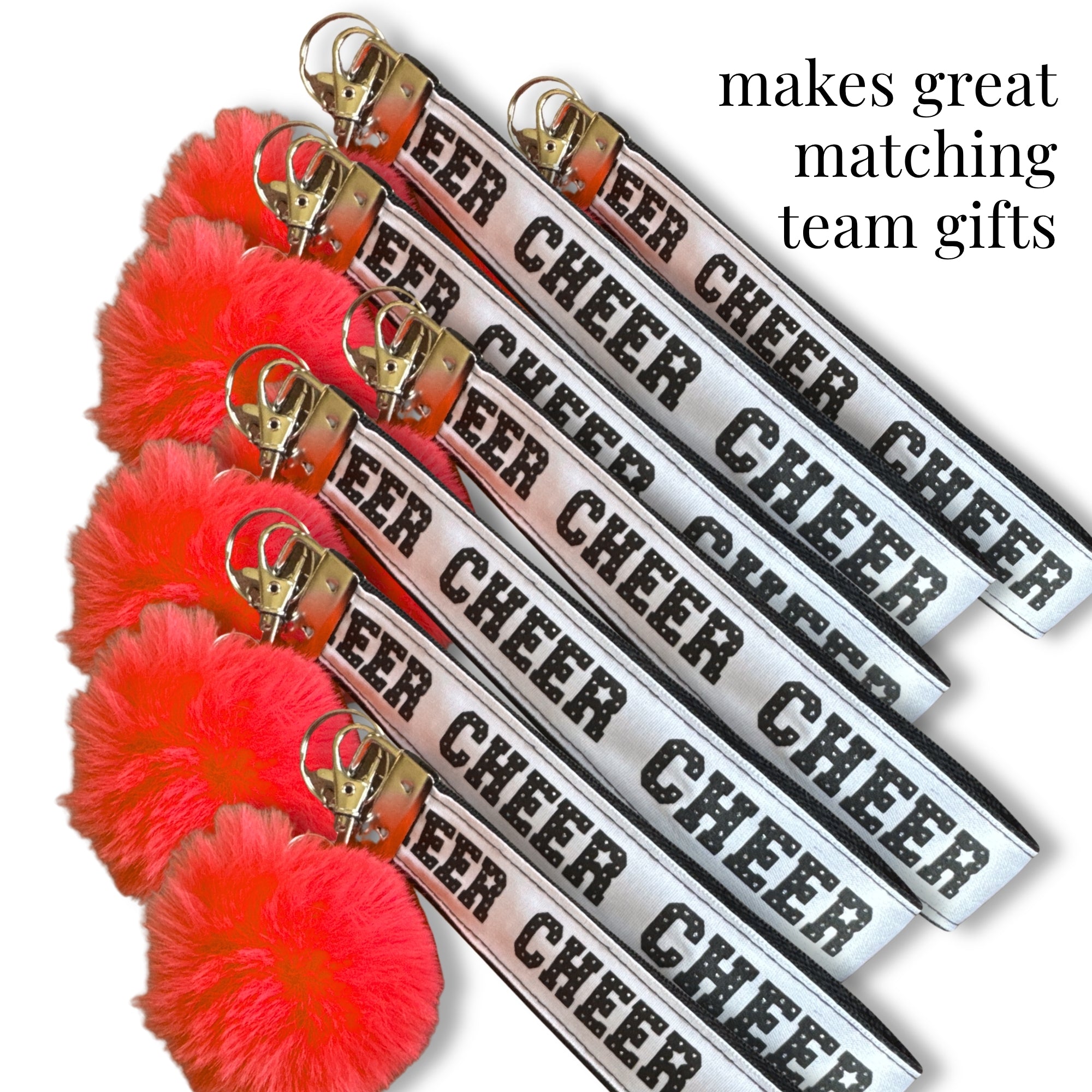 Cheer key tags with metal clips and fluffy pom-poms in red, pink, turquoise, and blue, perfect for bags and uniforms.