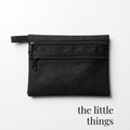 Black zippered bag for cheer or skate competition accessories with dual compartments.
