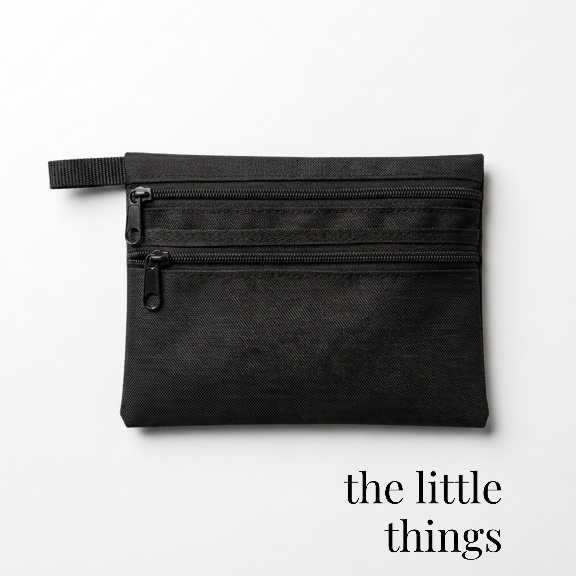 Black zippered bag for cheer or skate competition accessories with dual compartments.