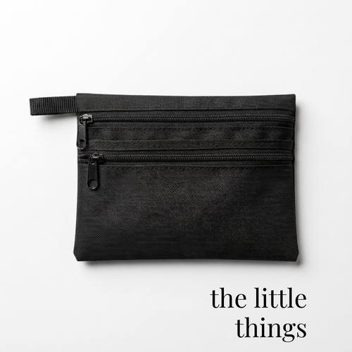Black zippered bag for cheer or skate competition accessories with dual compartments.