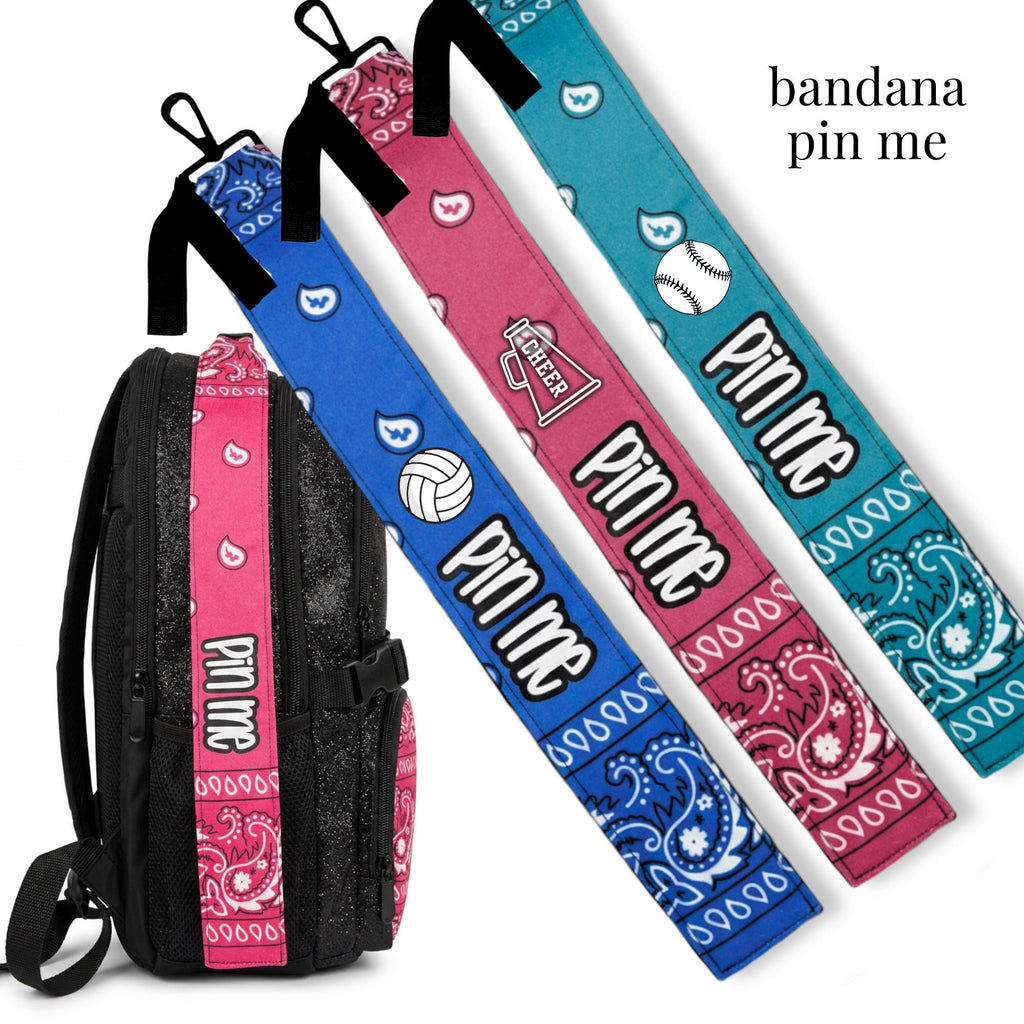 Cheer-themed Pin Me Bandana clips in blue, dark pink, and turquoise with sport icons for bag or uniform accessory.