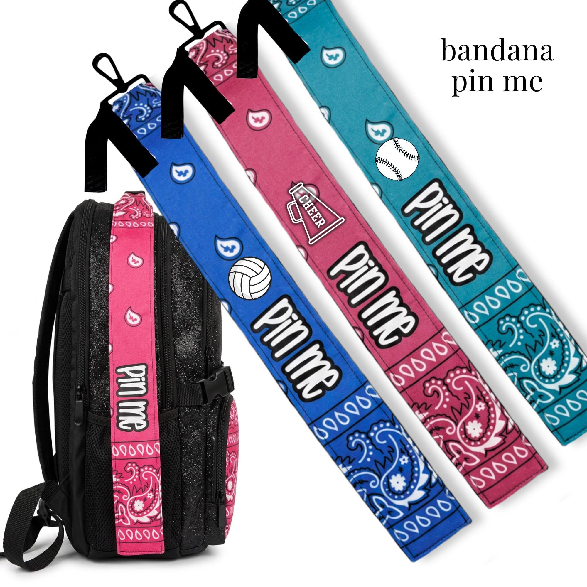 Cheer-themed Pin Me Bandana clips in blue, dark pink, and turquoise with sport icons for bag or uniform accessory.