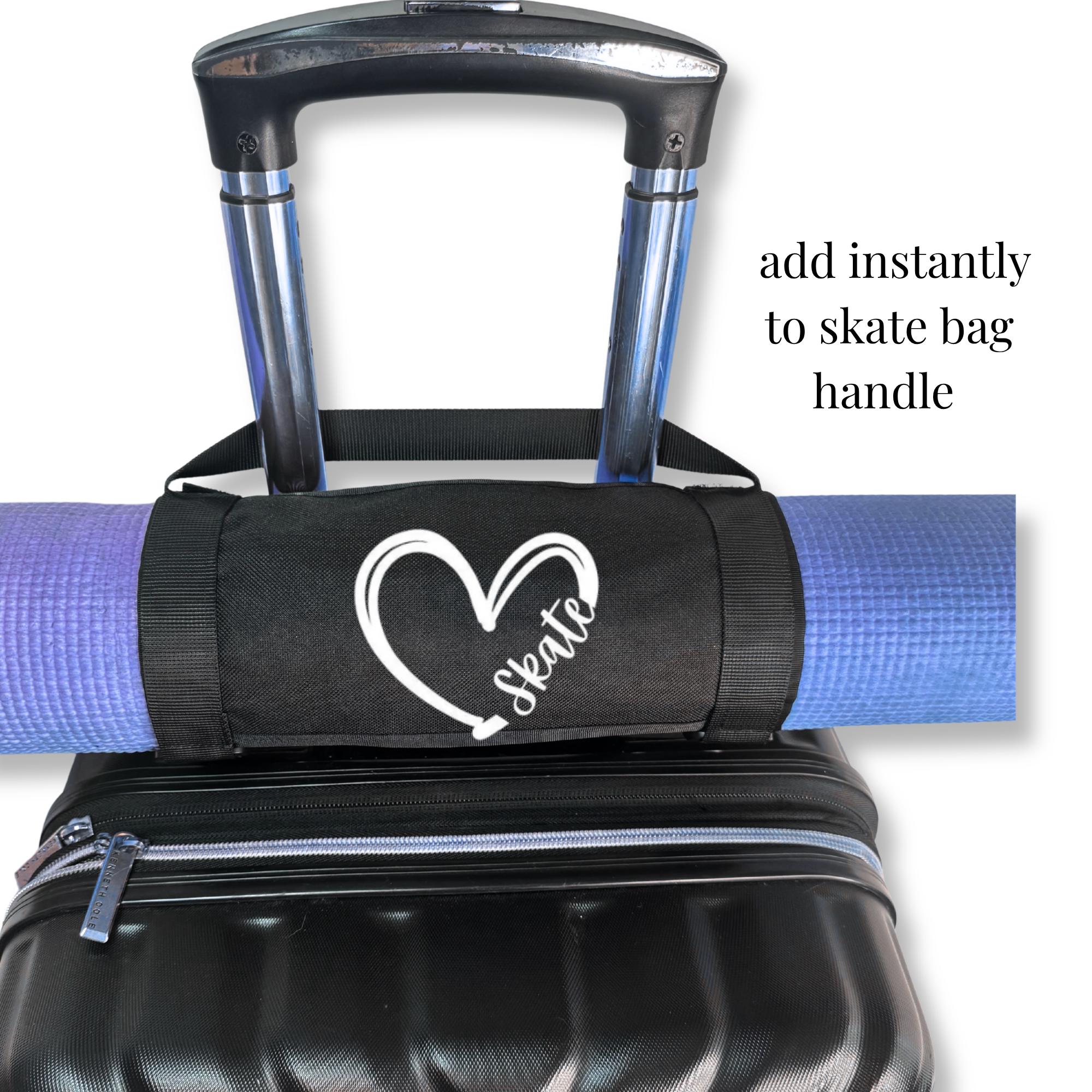 Black canvas mat holder attached to a luggage handle carrying a purple yoga mat with a white heart and skate design, ideal.