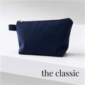 Navy blue zippered cheer and skate competition bag with fabric pull tab and gold zipper.