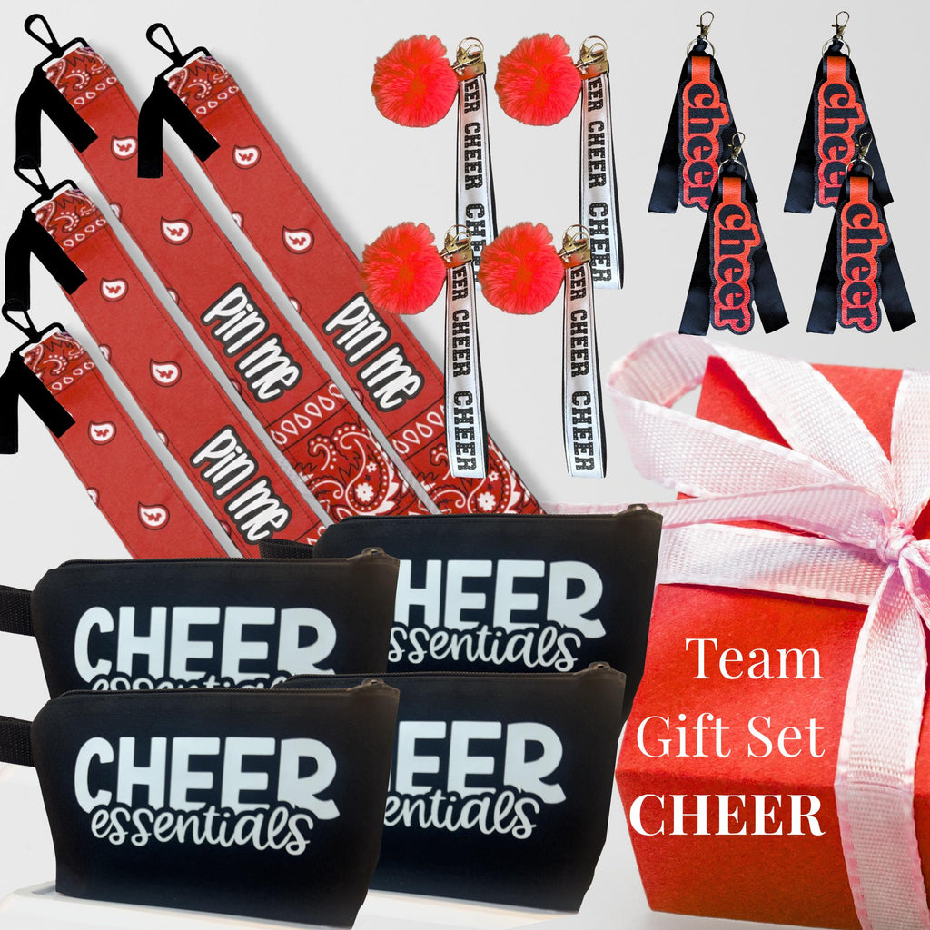 Red and black cheerleading gift set including canvas bag, pom-pom keychains, cheer-themed wristlets, and a pink gift box.