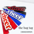 Cheer bag tags in red, blue, and black with bold lettering for competition bags and uniforms.