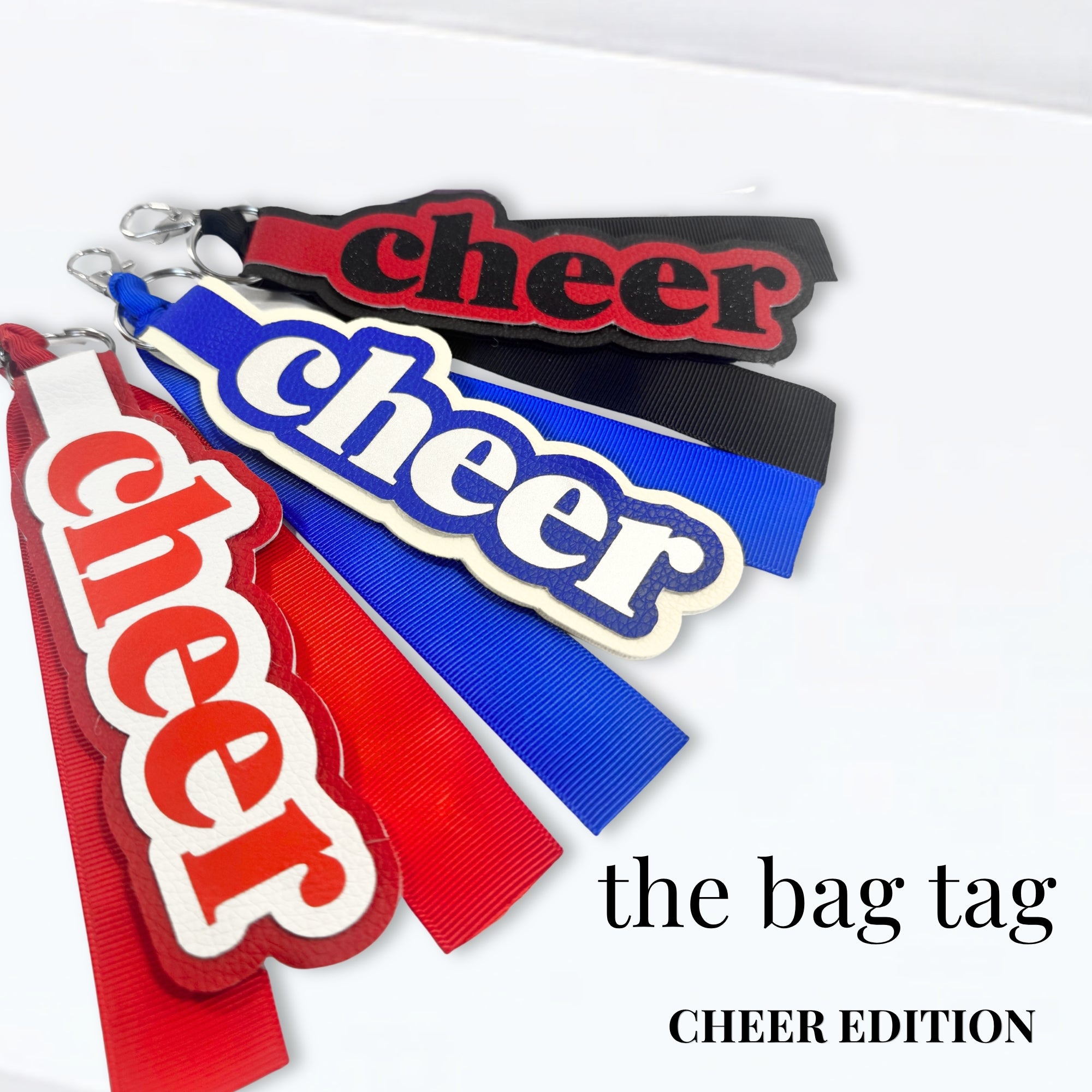 Cheer bag tags in red, blue, and black with bold lettering for competition bags and uniforms.