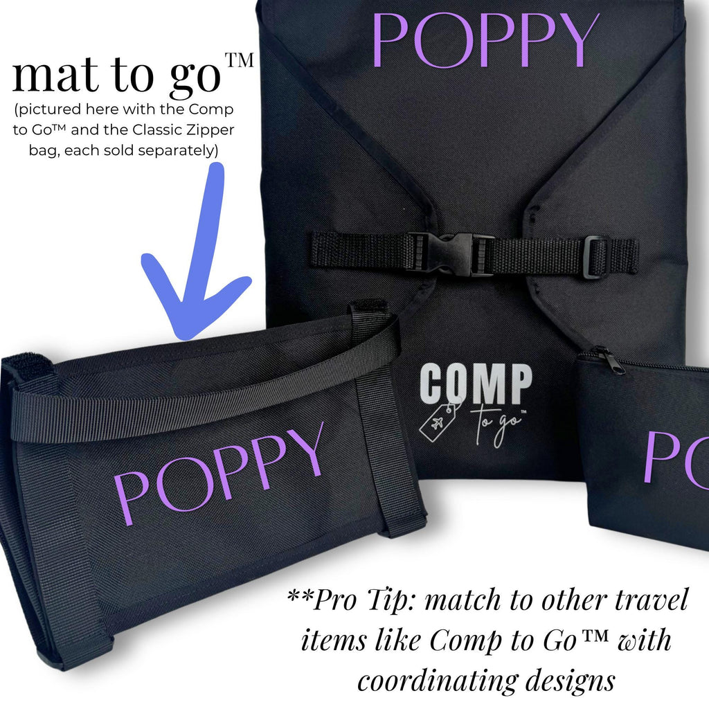 Black rectangular mat holder with adjustable buckle strap and "COMP" white logo, designed for carrying mats.