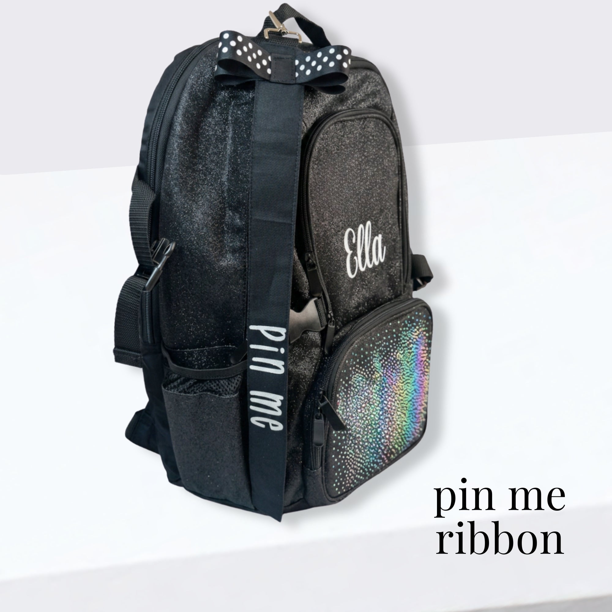 Black cheer bag with glittery texture, personalized "Ella" name, and holographic front pocket with pin me ribbon.