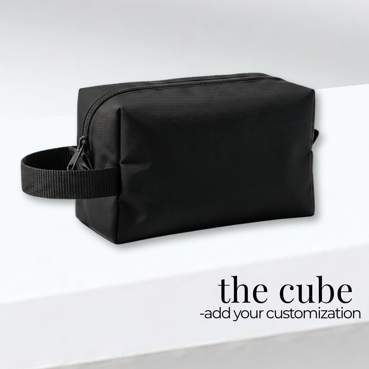 Black rectangular zippered travel bag with a side handle, made of durable fabric for cheer competition gear and uniforms.
