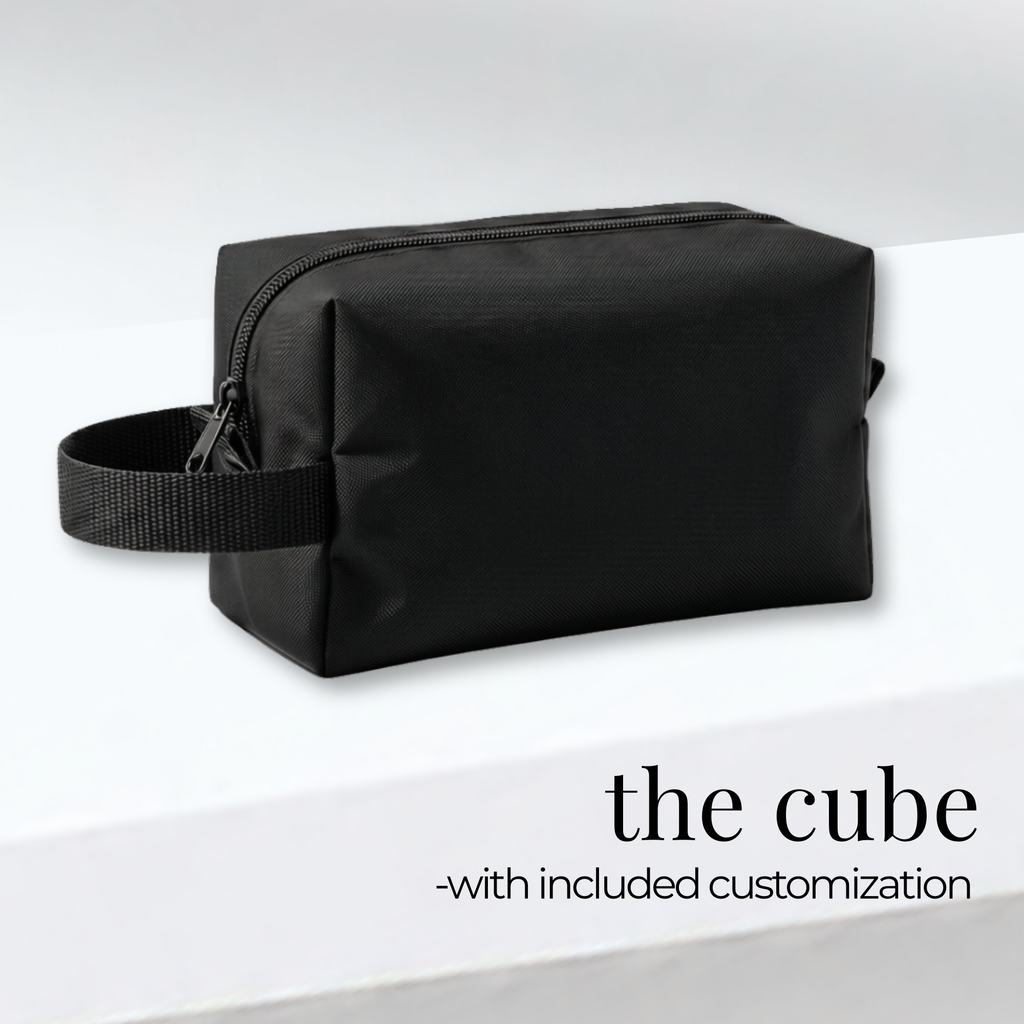 Black rectangular cheer and skate bag with side handle and zippered top, sturdy fabric design.