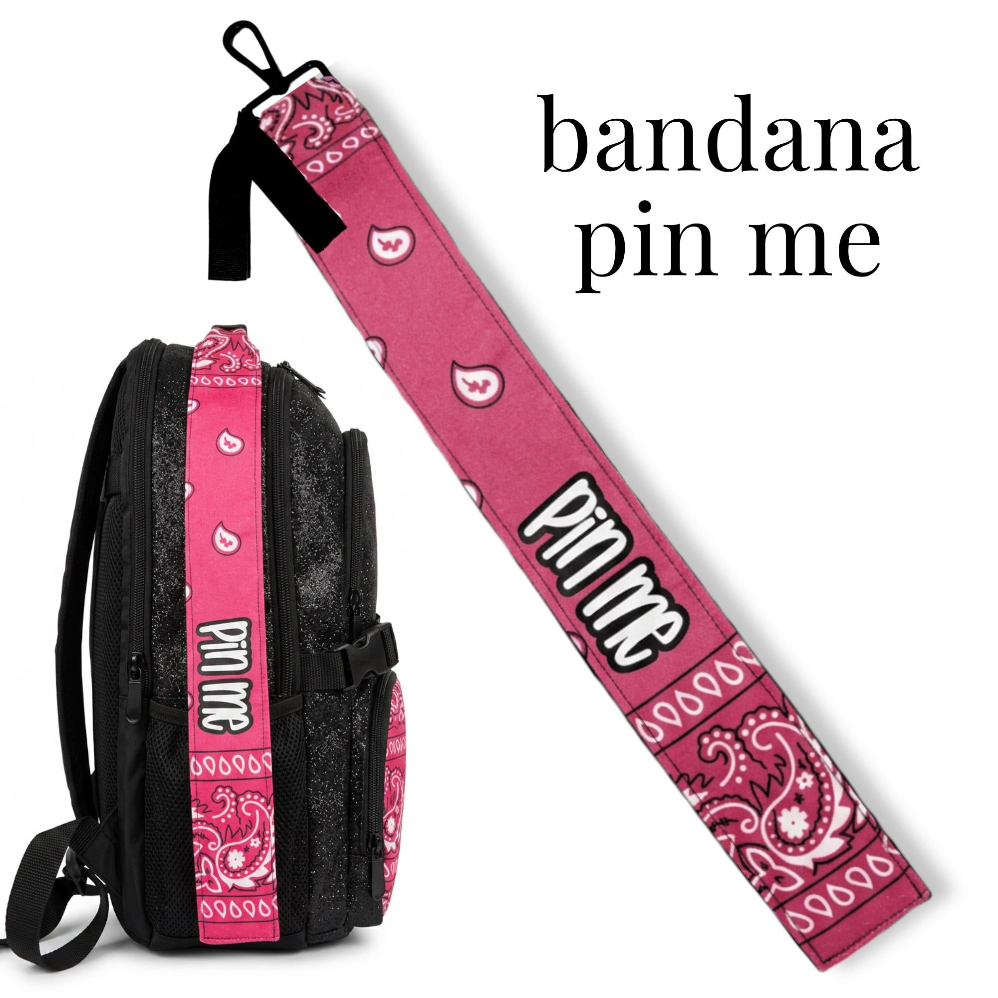 Pink bandana print pin on black cheer bag strap for competition or uniform accessory.