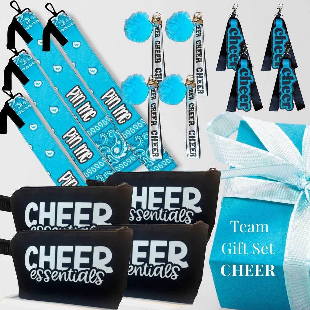 Blue and black cheerleading gift set with canvas bags, cheer bows, wristlets, and a gift box with a white ribbon.