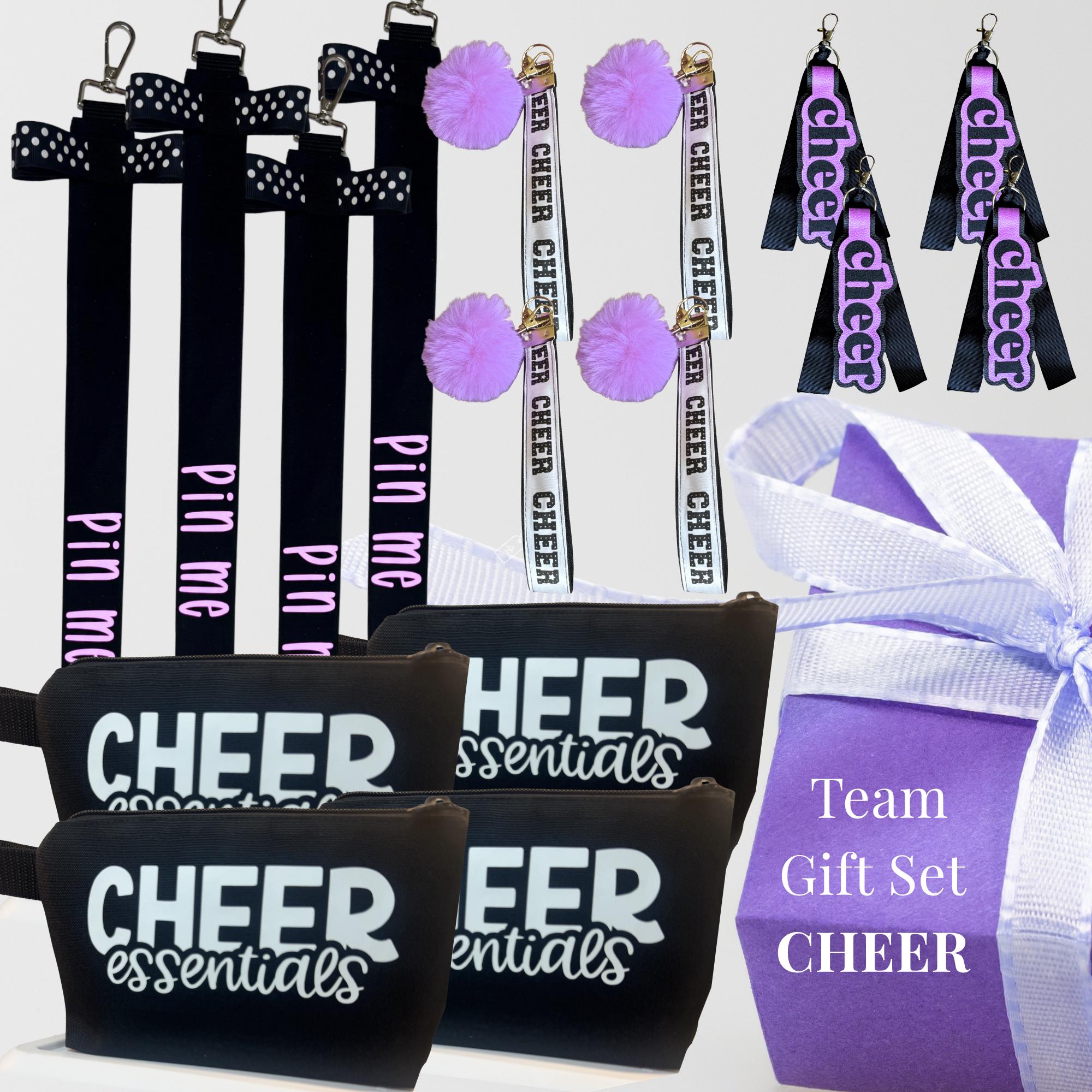 Black rectangular cheer wristlets with white "CHEER essentials" text, black pin me ribbon lanyards, black and purple cheer.
