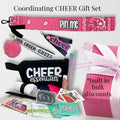 Pink cheer bag tag with bandana design, black cheer essentials wristlet, cheer pom pom keychain, lip gloss, and pink ribbon.