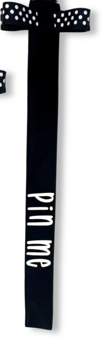 Black cotton ribbon pin with white polka dot bow and "pin me" text in white.